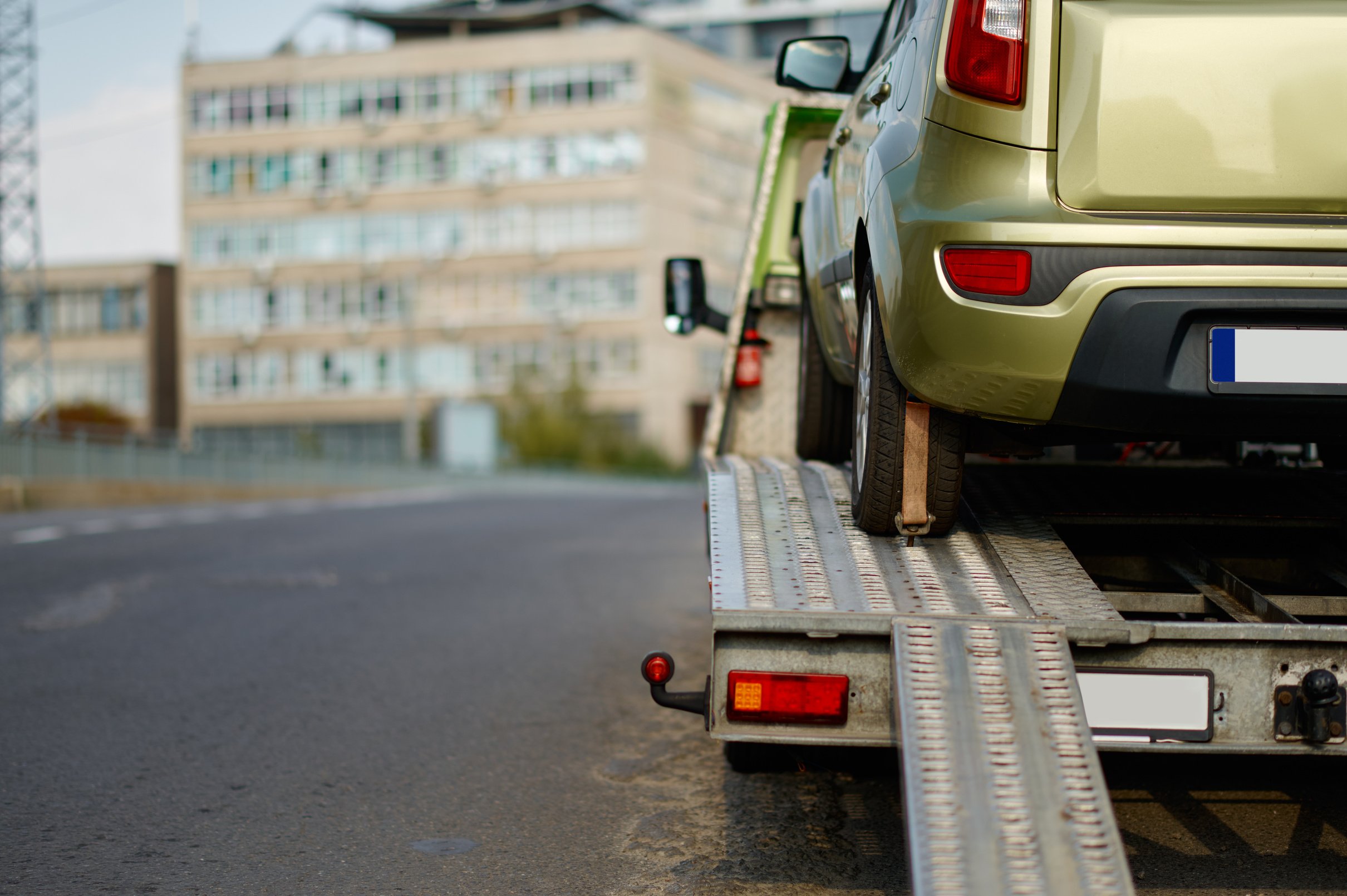 Broken Car Standing on Flatbed Tow Truck
